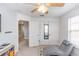 Bright bedroom featuring neutral walls, carpet flooring, a ceiling fan and a large built in closet at 10566 Green Ivy Ln, Orlando, FL 32832