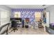 Well-lit bonus room with unique geometric wall decor and two large windows at 10566 Green Ivy Ln, Orlando, FL 32832