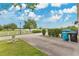 Community view showcasing picturesque lakeside scenery, with lush landscaping, and a street view with a white fence at 10566 Green Ivy Ln, Orlando, FL 32832
