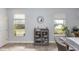 Dining area showcasing natural light from two windows and a display cabinet at 10566 Green Ivy Ln, Orlando, FL 32832