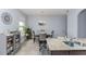 Bright dining room with modern chandelier, a large window, and plants on a shelf at 10566 Green Ivy Ln, Orlando, FL 32832