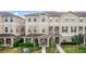 Attractive townhome showcasing a well-maintained facade and manicured landscaping at 10566 Green Ivy Ln, Orlando, FL 32832