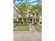 Charming two-story townhouse featuring a covered front porch and well-maintained landscaping at 10566 Green Ivy Ln, Orlando, FL 32832