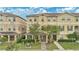 Inviting two-story townhome featuring lush landscaping and a covered front porch at 10566 Green Ivy Ln, Orlando, FL 32832
