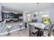 Open-concept kitchen with black cabinets, stainless steel appliances, and a dining table at 10566 Green Ivy Ln, Orlando, FL 32832