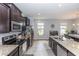 Well-equipped kitchen with granite countertops, stainless steel appliances, and ample cabinet space at 10566 Green Ivy Ln, Orlando, FL 32832