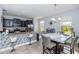 Modern kitchen featuring dark cabinetry, stainless steel appliances, and a dining area at 10566 Green Ivy Ln, Orlando, FL 32832