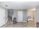 Spacious living area featuring neutral walls and tile floors, leading to the staircase at 10566 Green Ivy Ln, Orlando, FL 32832