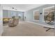 Bright living area with plush carpet, multiple windows, and comfortable seating at 10566 Green Ivy Ln, Orlando, FL 32832
