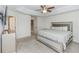 Large primary bedroom with a tray ceiling, neutral colors, and access to the en-suite bathroom at 10566 Green Ivy Ln, Orlando, FL 32832