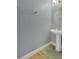 Stylish powder room featuring a pedestal sink, sleek fixtures, and neutral tiling for a clean modern look at 10566 Green Ivy Ln, Orlando, FL 32832