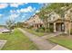 Beautiful street view of townhouses with well-kept lawns and sidewalks at 10566 Green Ivy Ln, Orlando, FL 32832