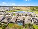 Bird's eye view of homes in a suburban community with a lake and green spaces at 10699 Petrillo Way, Winter Garden, FL 34787