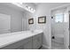 Bathroom featuring grey cabinets, white countertops, and a shower/tub combo at 10699 Petrillo Way, Winter Garden, FL 34787