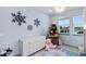 Comfortable bedroom featuring a dresser, snowflake décor, and a rocket-shaped bookshelf at 10699 Petrillo Way, Winter Garden, FL 34787