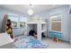 Bright bedroom featuring a loft bed, a snowflake rug, and light blue walls with white trim at 10699 Petrillo Way, Winter Garden, FL 34787