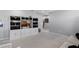 View of the bonus room featuring carpeted floors, a built-in entertainment center, and grey walls at 10699 Petrillo Way, Winter Garden, FL 34787