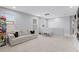 The neutral bonus room featuring a sofa, a small table and chairs, and an entertainment center at 10699 Petrillo Way, Winter Garden, FL 34787