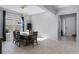 Bright dining room featuring modern flooring, a dining table, and access to the front foyer at 10699 Petrillo Way, Winter Garden, FL 34787