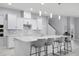 Bright, open kitchen features an island with seating, stainless steel appliances, and modern backsplash at 10699 Petrillo Way, Winter Garden, FL 34787