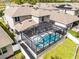 Aerial view of a house featuring a beautiful screened-in pool and jacuzzi combo at 10699 Petrillo Way, Winter Garden, FL 34787