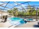 Sparkling pool with spa surrounded by screened enclosure and lush landscaping at 10699 Petrillo Way, Winter Garden, FL 34787