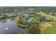 Stunning aerial view of golf course homes with lake views and mature trees at 1094 Red Maple Way, New Smyrna Beach, FL 32168