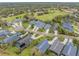 Aerial view of the neighborhood showcases lush landscaping, manicured lawns, and convenient access to the golf course at 1094 Red Maple Way, New Smyrna Beach, FL 32168