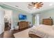 Bedroom featuring hardwood floors, a modern ceiling fan, and a door to the backyard at 1094 Red Maple Way, New Smyrna Beach, FL 32168