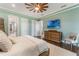 Bedroom featuring hardwood floors, a modern ceiling fan, and a view into the bathroom at 1094 Red Maple Way, New Smyrna Beach, FL 32168