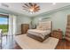 Spacious bedroom with dark wood floors and a ceiling fan at 1094 Red Maple Way, New Smyrna Beach, FL 32168