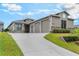 Beautiful craftsman-style home featuring a well-manicured lawn and a spacious three-car garage at 1094 Red Maple Way, New Smyrna Beach, FL 32168