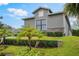 Attractive home showcasing manicured shrubbery and palm trees, nestled on a neatly maintained lawn at 1094 Red Maple Way, New Smyrna Beach, FL 32168