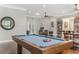 Game room features pool table, hardwood floors, and access to other rooms at 1094 Red Maple Way, New Smyrna Beach, FL 32168