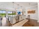 Modern kitchen island with marble countertop, stainless steel appliances, and hardwood floors at 1094 Red Maple Way, New Smyrna Beach, FL 32168