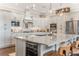 Modern kitchen with gray cabinetry, stainless steel appliances, and a granite island with bar seating at 1094 Red Maple Way, New Smyrna Beach, FL 32168