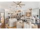 Bright living room flows into open kitchen, featuring hardwood floors and stylish, comfortable furnishings at 1094 Red Maple Way, New Smyrna Beach, FL 32168