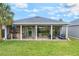 Beautifully landscaped backyard features a covered patio with an outdoor kitchen and seating at 1094 Red Maple Way, New Smyrna Beach, FL 32168