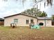 Large backyard featuring a playhouse, a play structure, and a grill on a patio at 1197 Village Forest Pl, Winter Park, FL 32792