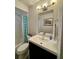 Bright, clean bathroom features vanity with mosaic mirror and bathtub at 1197 Village Forest Pl, Winter Park, FL 32792