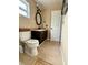 A modest bathroom features a toilet, vanity, and standard tile flooring at 1197 Village Forest Pl, Winter Park, FL 32792