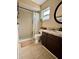 Compact bathroom featuring a walk-in shower and vanity with storage at 1197 Village Forest Pl, Winter Park, FL 32792