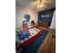 Fun bedroom with hardwood floors, a themed car bed, and playful decor for an imaginative and cozy space at 1197 Village Forest Pl, Winter Park, FL 32792