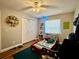 Cozy bedroom featuring hardwood floors, soft lighting, and playful decor for a comfortable and inviting space at 1197 Village Forest Pl, Winter Park, FL 32792