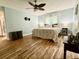 Bright bedroom with wood floors, ceiling fan, and natural light from large window at 1197 Village Forest Pl, Winter Park, FL 32792