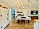 Open dining area with hardwood floors, chandelier, and seamless flow to other rooms for modern living and entertaining at 1197 Village Forest Pl, Winter Park, FL 32792