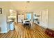 Open dining area with hardwood floors, chandelier, and seamless flow to kitchen, creating a welcoming and functional space at 1197 Village Forest Pl, Winter Park, FL 32792