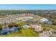 An aerial view highlights the community's clubhouse, pool, ponds, and manicured landscaping at 125 Links Terrace Blvd, Daytona Beach, FL 32124