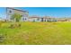 Well-maintained backyard with lush grass, landscaping, and neighboring houses at 125 Links Terrace Blvd, Daytona Beach, FL 32124