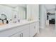 Bright bathroom features a double sink vanity with quartz counters and storage at 125 Links Terrace Blvd, Daytona Beach, FL 32124